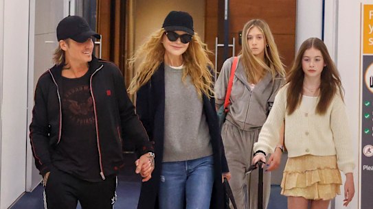 Incoming: Keith Urban and Nicole Kidman arriving into Sydney with their daughters Sunday, 14, and Faith, 11.