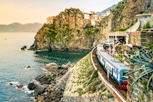 A train rolls through Manarola, Cinque Terre.