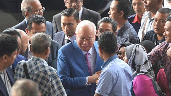 Former Malaysian prime minister Najib Razak, centre, arrives at court in Kuala Lumpur for his trial on Tuesday.