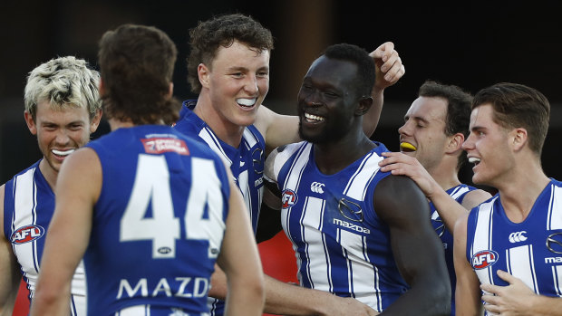 Majak Daw is mobbed by teammates.