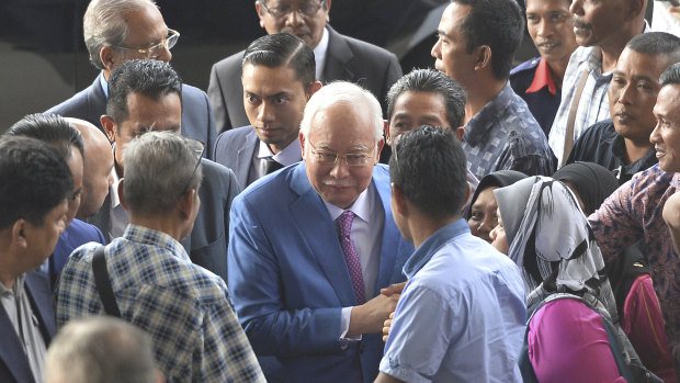 Former Malaysian prime minister Najib Razak, centre, arrives at court in Kuala Lumpur for his trial on Tuesday.