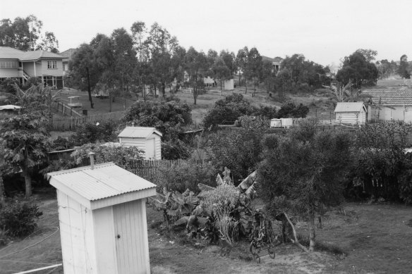 Suburban properties with outhouses, a key function of backyards until toilets moved inside.