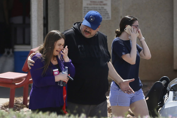 People arrive at MacArthur Elementary looking for family and friends. The school was being used as a reunification centre in the aftermath of the shooting.