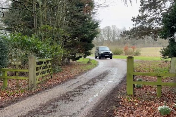 A car moves out of the Royal estate in Sandringham.