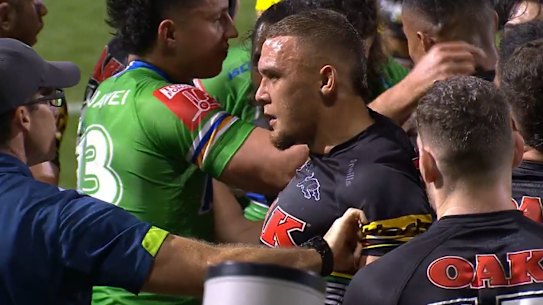 The Raiders trainer pulls the jersey of Panthers forward James Fisher-Harris on Friday night.