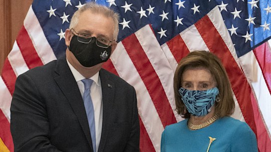 Australian Prime Minister Scott Morrison, left, shakes hands with US House Speaker Nancy Pelosi.