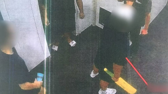 Three detainees confront the prison officer with a plastic cricket bat.