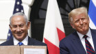 Israel's Prime Minister Benjamin Netanyahu and US President Donald Trump hold signed documents relating to the Middle East deal. 