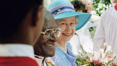 Queen Elizabeth II emerges from St. George’s Cathedral with Archbishop Desmond Tutu at the end of a service to commemorate Human Rights Day, in Cape Town in 1995.