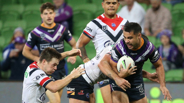 Head knock: Roosters five-eighth Luke Keary reels out of a tackle after tackling Storm fullback Jahrome Hughes.