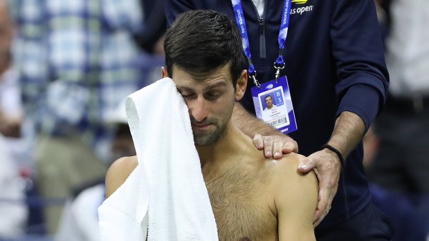Novak Djokovic receiving treatment before withdrawing from his match at the US Open.