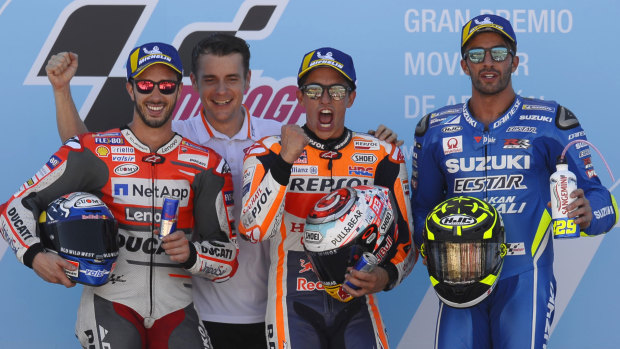 Podium: Race winner Marc Marquez (centre) celebrates with second-placed Andrea Dovizioso (left) and Andrea Iannone.