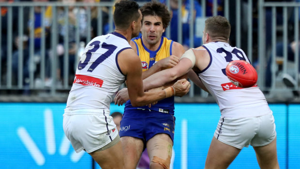 Retribution: Eagle Andrew Gaff was taken from the field after being double-teamed in a tackle by Dockers Michael Johnson and Luke Ryan.
