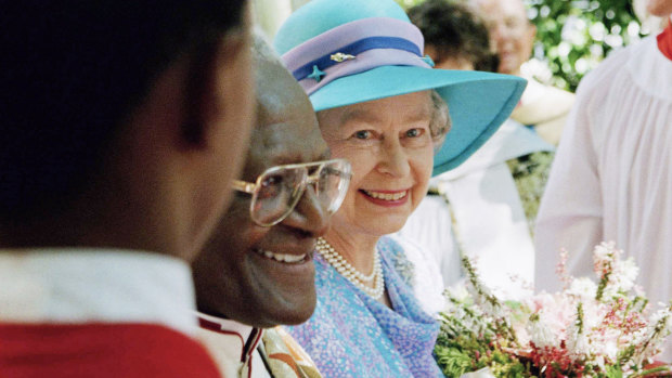Queen Elizabeth II emerges from St. George’s Cathedral with Archbishop Desmond Tutu at the end of a service to commemorate Human Rights Day, in Cape Town in 1995.