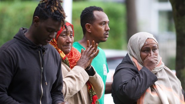 Shocked worshippers emerge from one of the mosques.