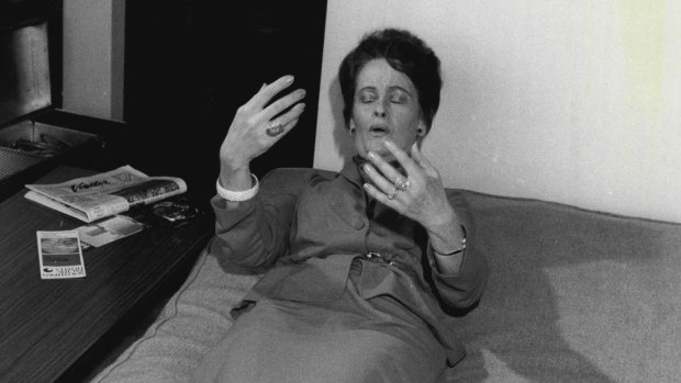 American ghosthunter Lorraine Warren shows how she lay back on a bed in the Gladesville home and explains that she felt vibrations. 