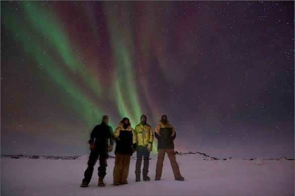 Knoff (far right) with colleagues in Antarctica. “Winter field trip under the southern lights, temperature around minus 20 degrees hence every layer of clothing required!” 