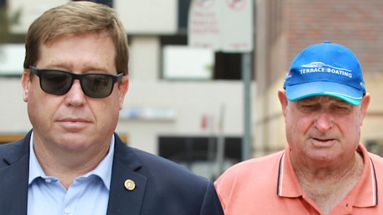 Former NSW police minister Troy Grant leaves Burwood Local Court with his father Kenneth Grant who appeared on charges relating to a hit-and-run road death. 