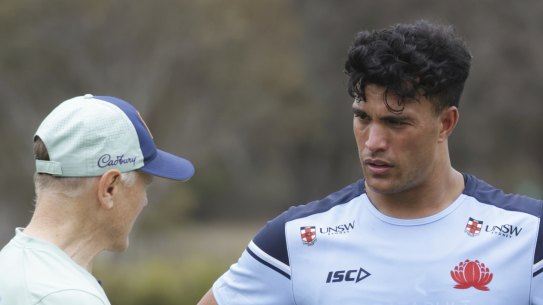 Joseph Suaalii chatting to coach Joe Schmidt in camp with the Wallabies.