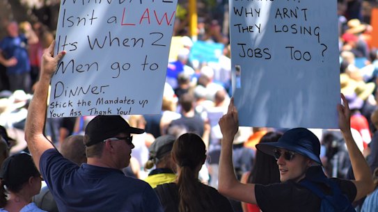 People march through Perth’s CBD holding signs and calling out the word “freedom” in protest of vaccine mandates and strict borders. 