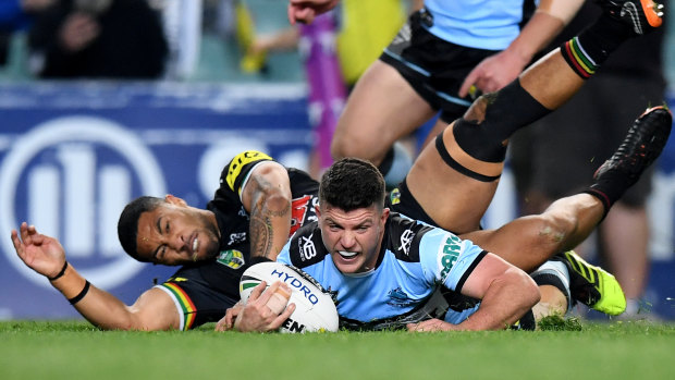 Night to remember: Chad Townsend dives over for Cronulla.
