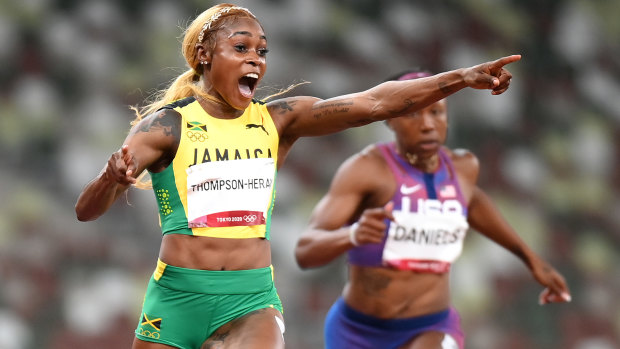 Elaine Thompson-Herah celebrates her gold.