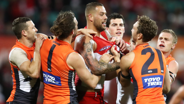 Lance Franklin of the Swans scraps with Matthew Buntine.