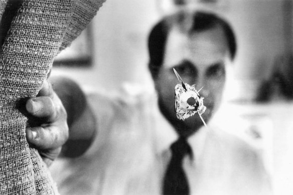 John Newman in his electoral office in 1991 after a bullet was fired through its window.