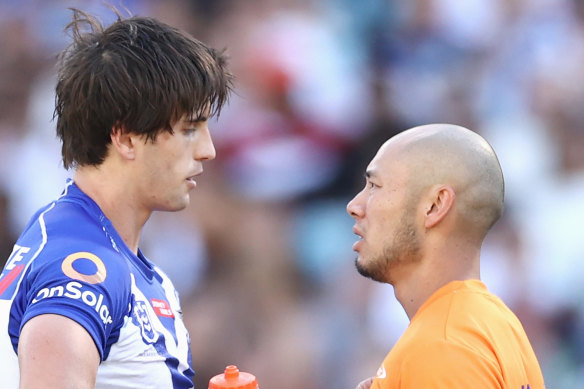 Lachlan Lewis is assessed on the field for concussion by the Bulldogs trainer.