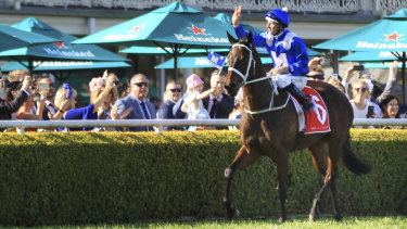 Unbeatable: Hugh Bowman salutes the Randwick crowd coming back on Winx.