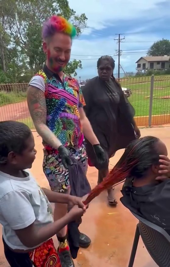 Working holiday: Mykey O’Halloran with locals in an outdoor area of his Galiwin’ku pop up salon.