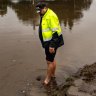 Resident Steve Arnold walks in floodwaters at Moorebank, in Sydney’s west, on Monday.