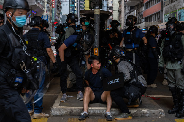 A pro-democracy supporter is detained by police during an anti-government rally on May 24 in Hong Kong.