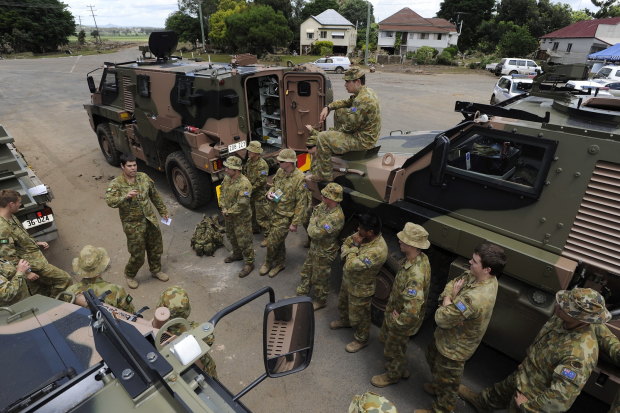 Platoon Commander Captain Brent Mickelberg briefs troops before a ground search during the 2011 floods.