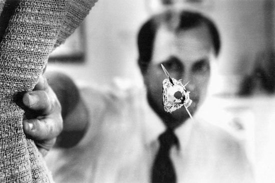 John Newman in his electoral office in 1991 after a bullet was fired through its window.