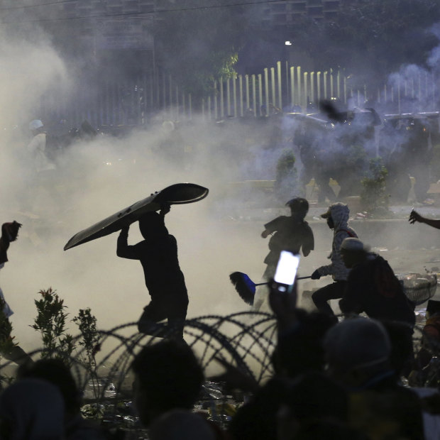 Rocks, riot shields and tear gas: central Jakarta on Wednesday night.