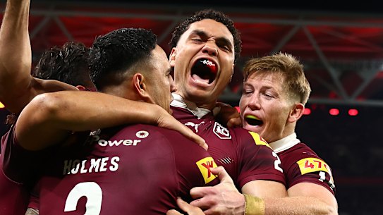 Xavier Coates celebrates a try for the Maroons.
