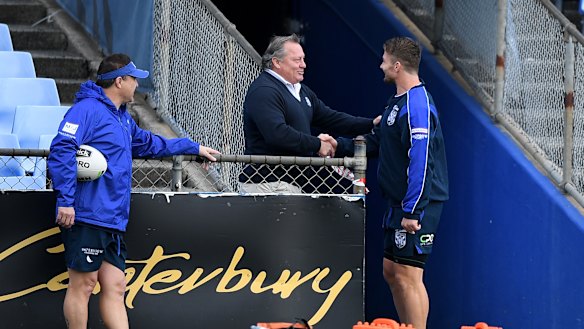 Costly shake? Bulldogs legend Terry Lamb greets Kieran Foran before training on Thursday.