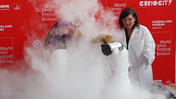 Queensland Science Minister Leeanne Enoch engages in some hands-on science at the World Science Festival Brisbane 2020 program launch on Sunday.