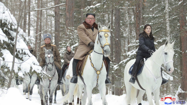 North Korean leader Kim Jong-un, centre, rides on a white horse during his visit to Mount Paektu.