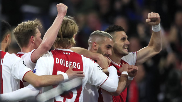 Better times: Ajax's Hakim Ziyech celebrates with Dusan Tadic (right) after scoring his side's second goal.