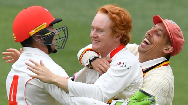 Come in spinner: Lloyd Pope celebrates with Harry Nielsen and Jake Lehmann the wonder dismissal of Steve O'Keefe.
