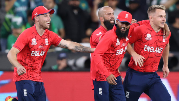 England’s players storm out onto the MCG to celebrate victory.