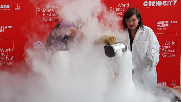 Queensland Science Minister Leeanne Enoch engages in some hands-on science at the World Science Festival Brisbane 2020 program launch on Sunday.