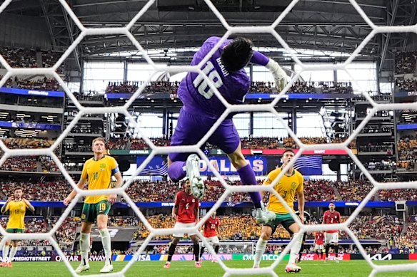 Patrick Beach leaps to stop a goal during the Socceroos’ match against Egypt.