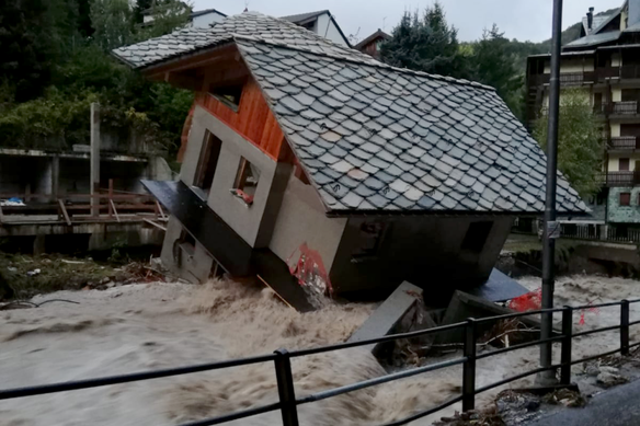 A building is toppled over by the Cervo river in spate due to heavy rains in Biella, northern Italy, on Saturday, October 3. 
