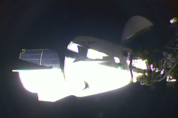 The SpaceX Dragon crew capsule, with NASA astronauts Doug Hurley and Robert Behnken aboard, docks with the International Space Station.