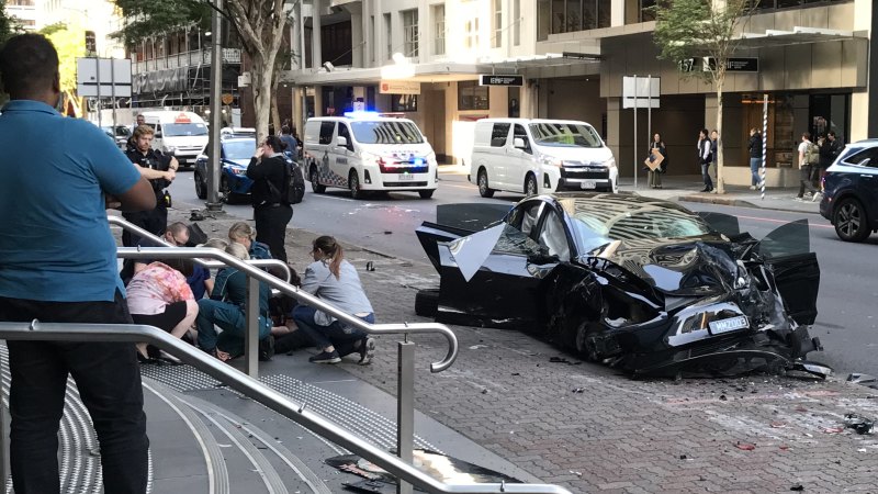 Three hospitalised after Tesla and ambulance crash in Brisbane CBD