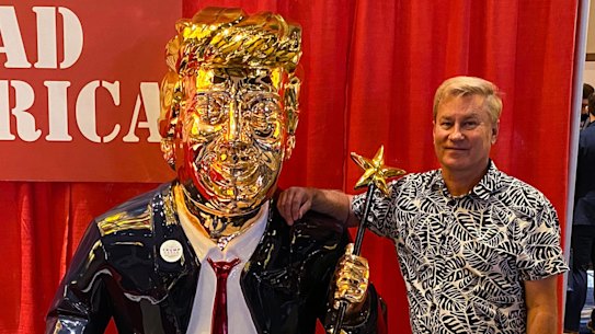 Tommy Zegan with his golden Donald Trump statue at the Conservative Political Action Conference in Orlando.