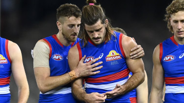 Marcus Bontempelli consoles Josh Bruce after his injury, and after the loss to Essendon. 